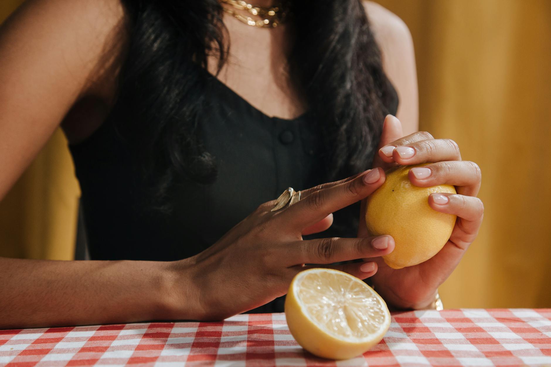 Woman holding a fresh lemon, representing clarity and connection