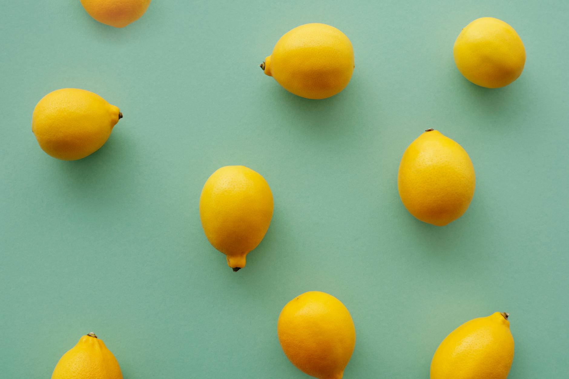 Bright yellow lemons arranged on a soft background, symbolizing renewal and sensuality