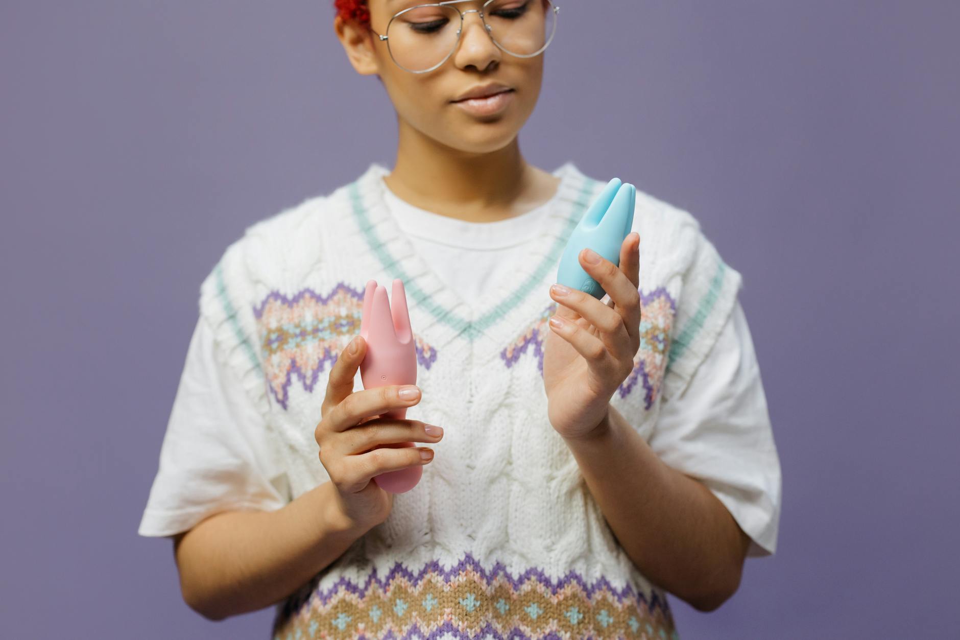 Person holding a lemon vibrator with curiosity, exploring a new clitoral suction toy