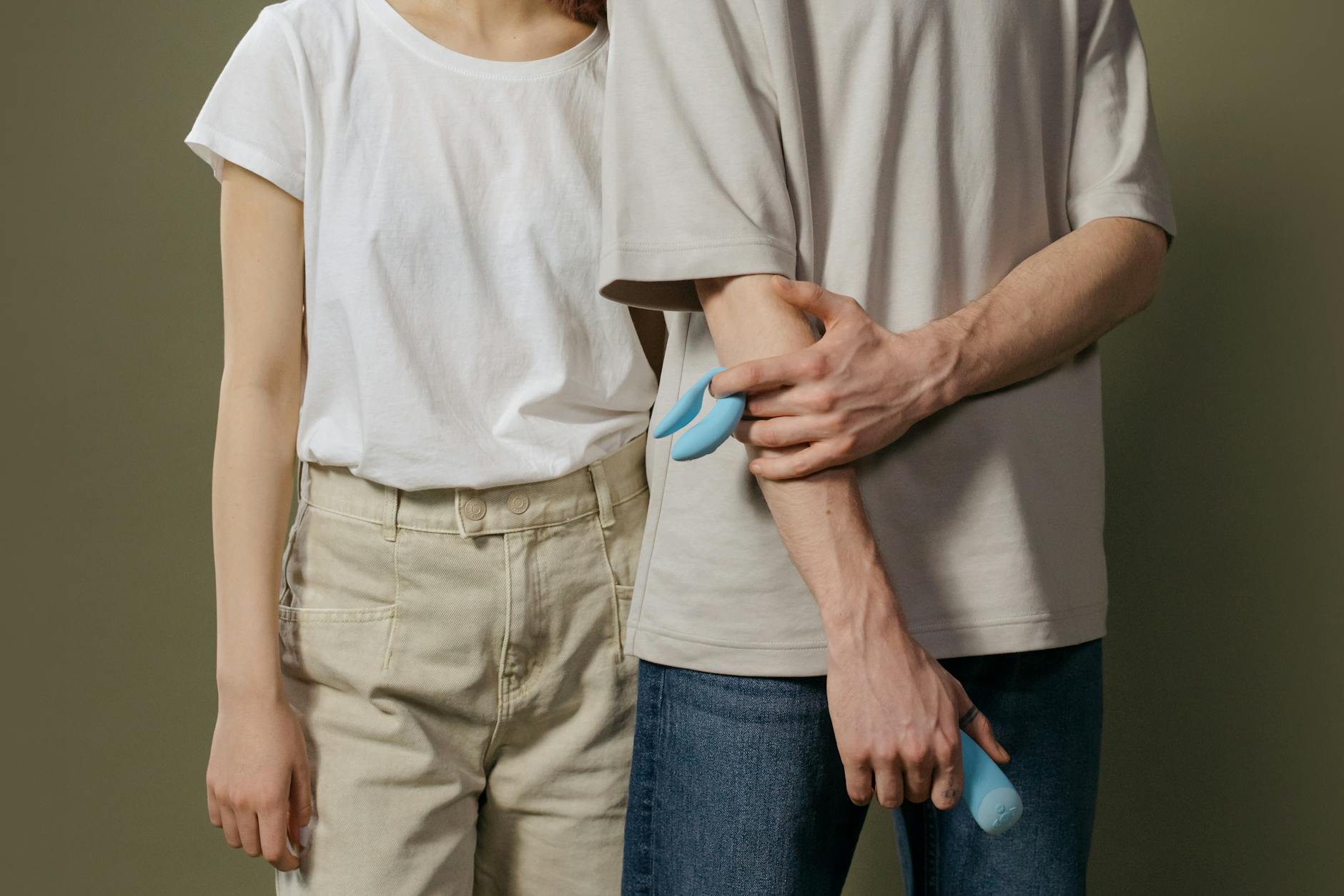 Woman holding clitoral vibrators, exploring sensation and pleasure recovery